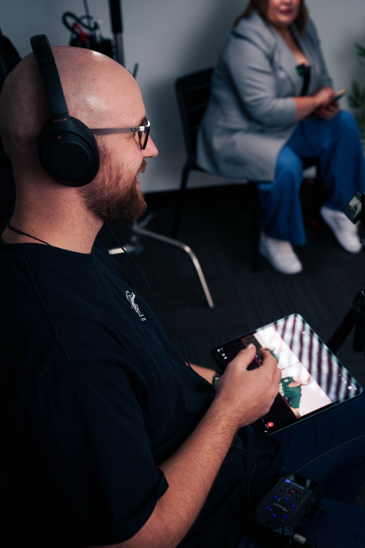 Sound recordist monitoring audio during a sports interview shoot